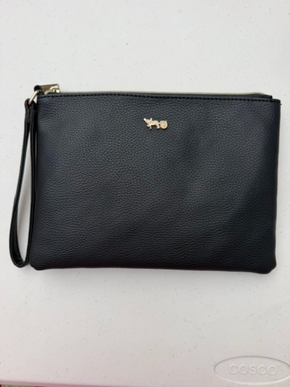 black pebbled faux-leather crossbody wristlet featuring a small gold-tone horse
